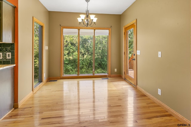 interior space featuring light hardwood / wood-style floors and a notable chandelier