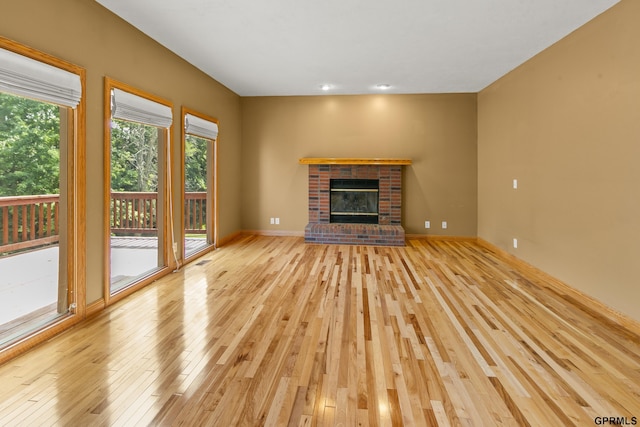 unfurnished living room featuring light hardwood / wood-style floors and a fireplace