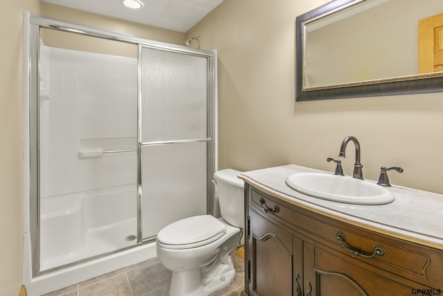 bathroom with toilet, an enclosed shower, and vanity