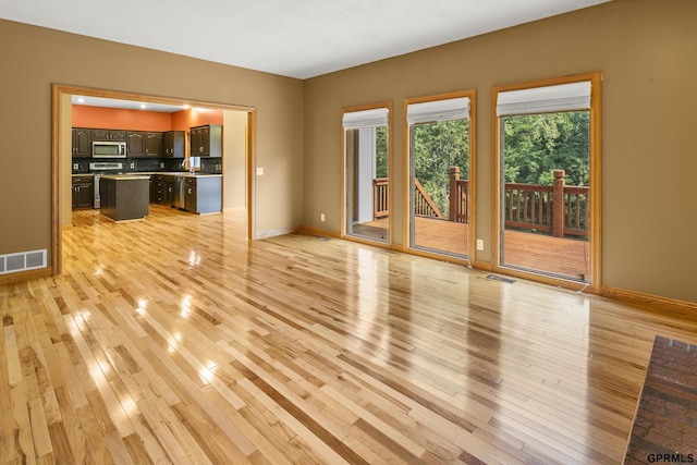 unfurnished living room featuring light hardwood / wood-style flooring