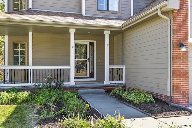 view of exterior entry featuring a porch