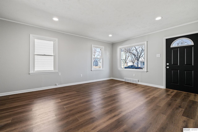 entrance foyer featuring crown molding and dark hardwood / wood-style flooring