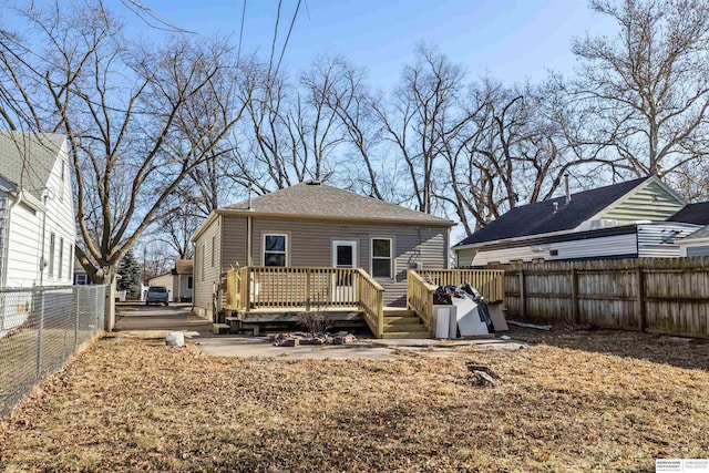 back of house with a wooden deck