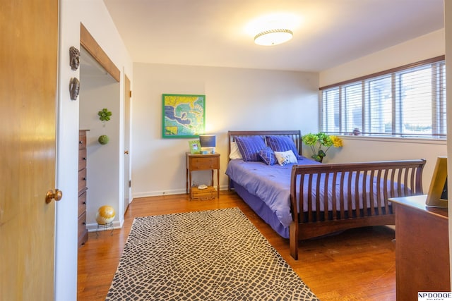 bedroom with hardwood / wood-style flooring