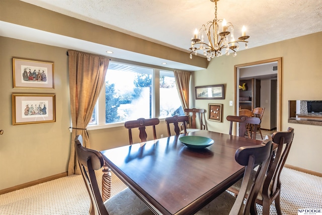 carpeted dining space with a textured ceiling and an inviting chandelier