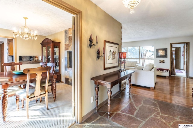 dining room with a chandelier and a textured ceiling