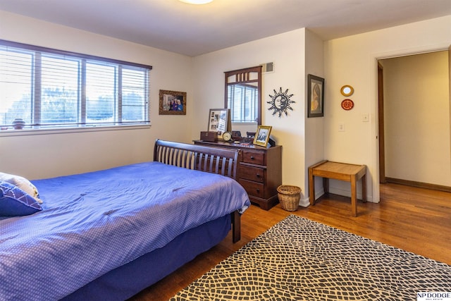 bedroom with hardwood / wood-style flooring