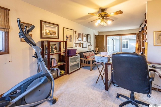 carpeted home office featuring ceiling fan