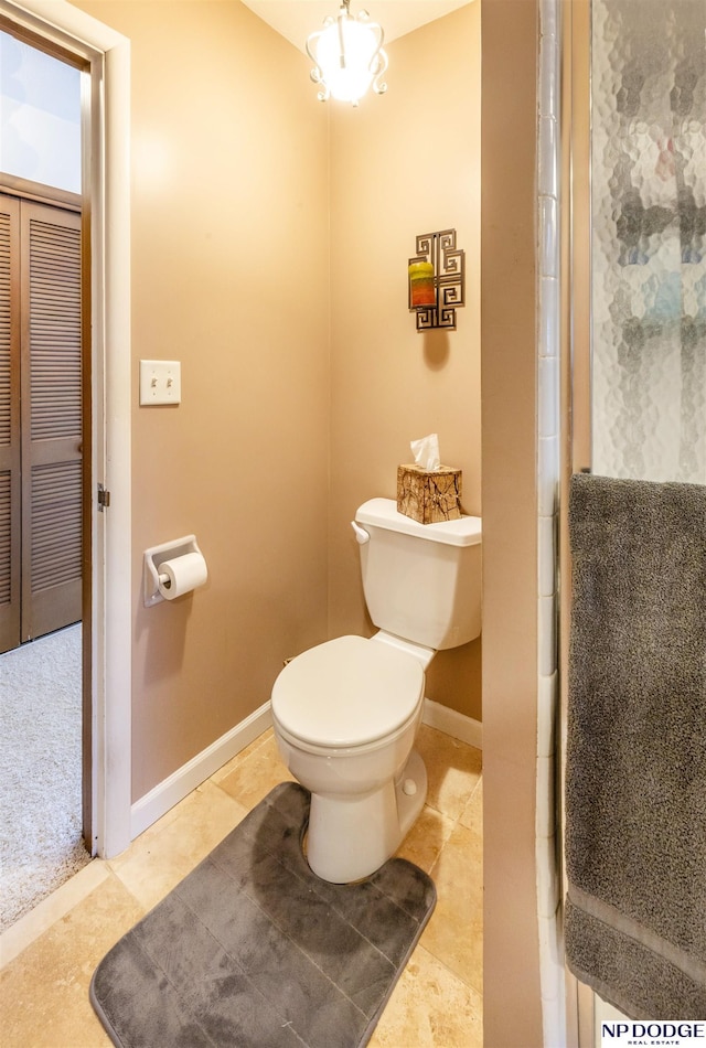 bathroom with tile patterned floors, a shower with shower door, and toilet