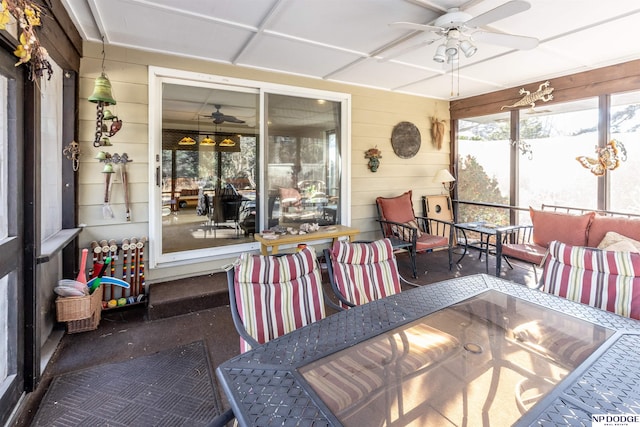 sunroom featuring ceiling fan