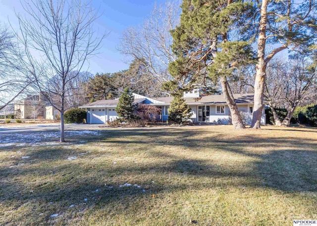 ranch-style home featuring a front lawn and a garage