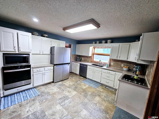 kitchen featuring sink, a textured ceiling, decorative backsplash, white cabinets, and black appliances