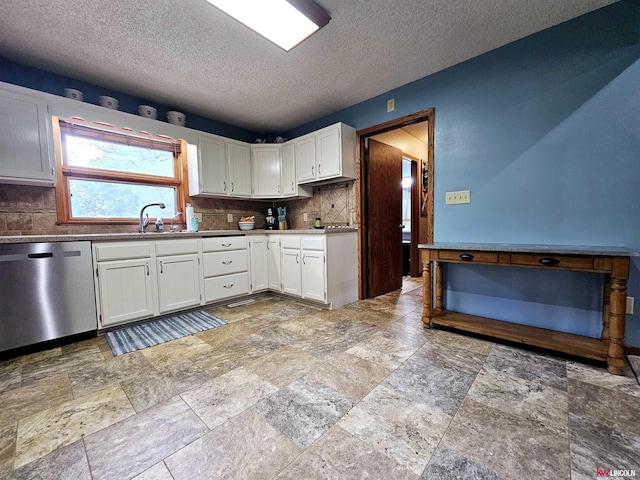 kitchen with tasteful backsplash, dishwasher, white cabinets, and sink