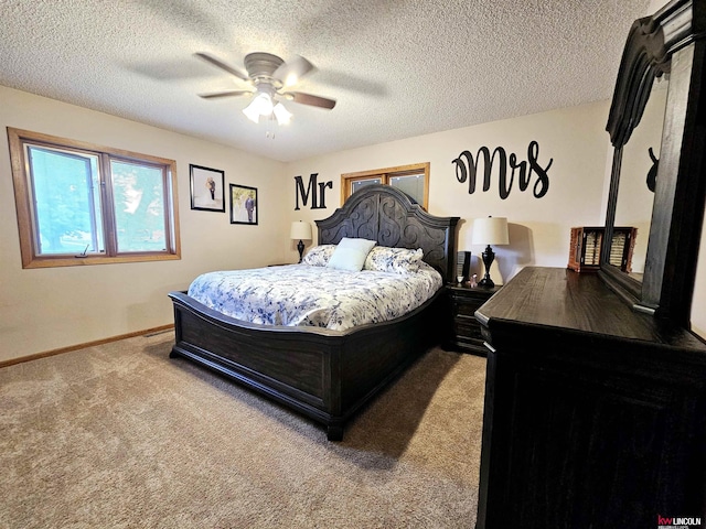 carpeted bedroom with ceiling fan and a textured ceiling