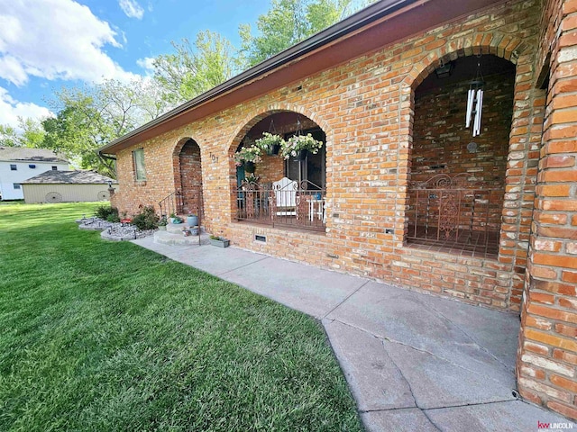 doorway to property with a lawn