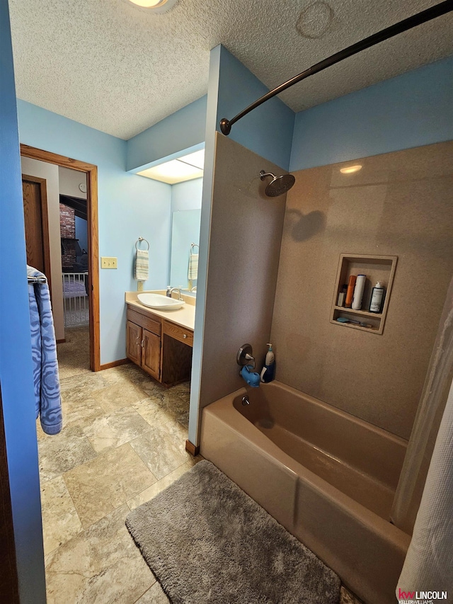 bathroom featuring shower / bath combination with curtain, a textured ceiling, and vanity