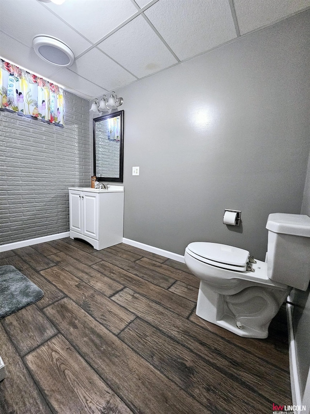 bathroom featuring a paneled ceiling, vanity, and toilet