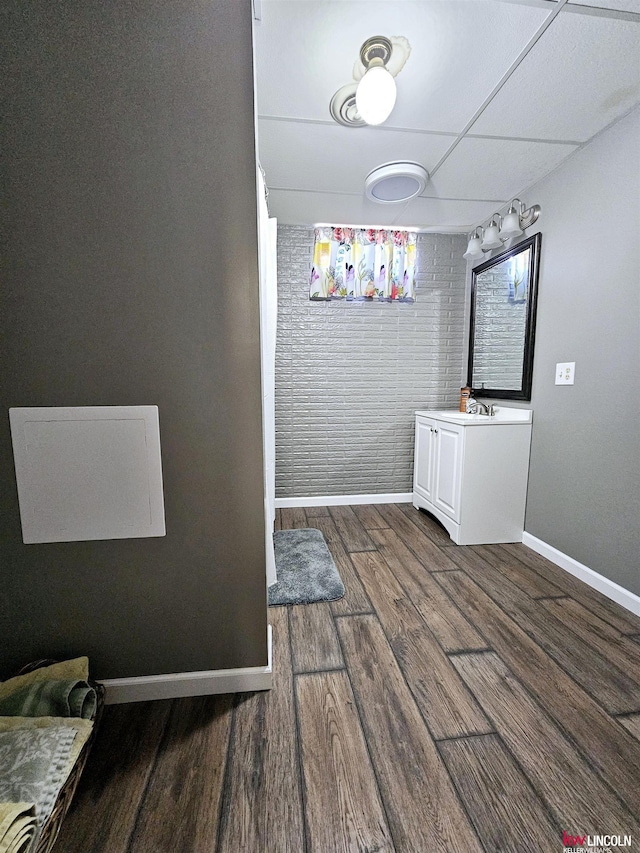 interior space featuring hardwood / wood-style floors and a paneled ceiling