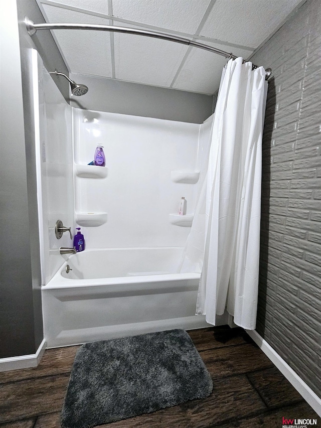 bathroom featuring hardwood / wood-style flooring and shower / bath combination with curtain