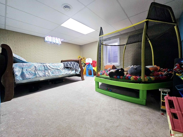 bedroom with a paneled ceiling and carpet