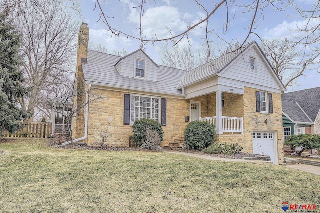 view of front of home with a porch, a garage, and a front lawn