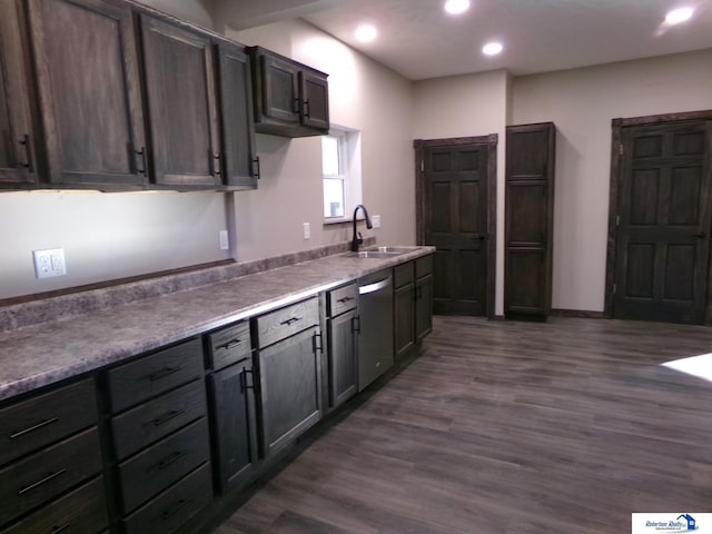 kitchen featuring dark hardwood / wood-style flooring, dark brown cabinetry, sink, and stainless steel dishwasher