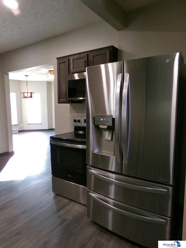 kitchen featuring appliances with stainless steel finishes, dark brown cabinets, decorative light fixtures, an inviting chandelier, and dark hardwood / wood-style floors