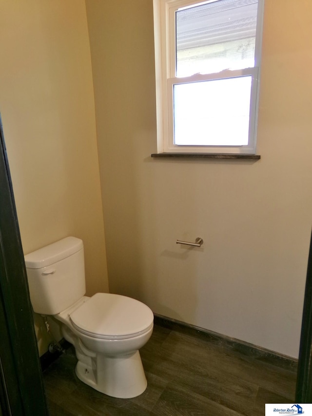 bathroom featuring hardwood / wood-style flooring and toilet