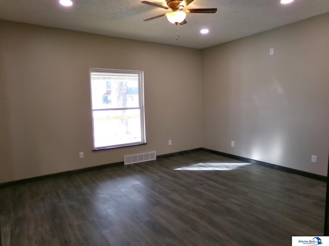 unfurnished room with dark hardwood / wood-style floors and ceiling fan