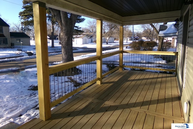 snow covered deck with covered porch