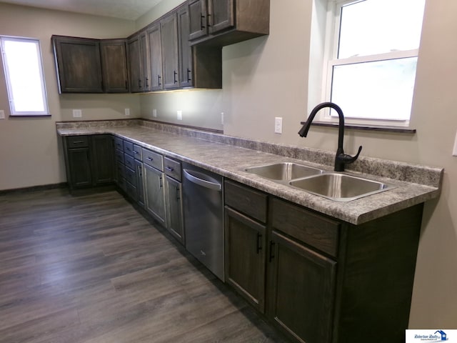 kitchen featuring dark hardwood / wood-style flooring, dark brown cabinetry, stainless steel dishwasher, and sink