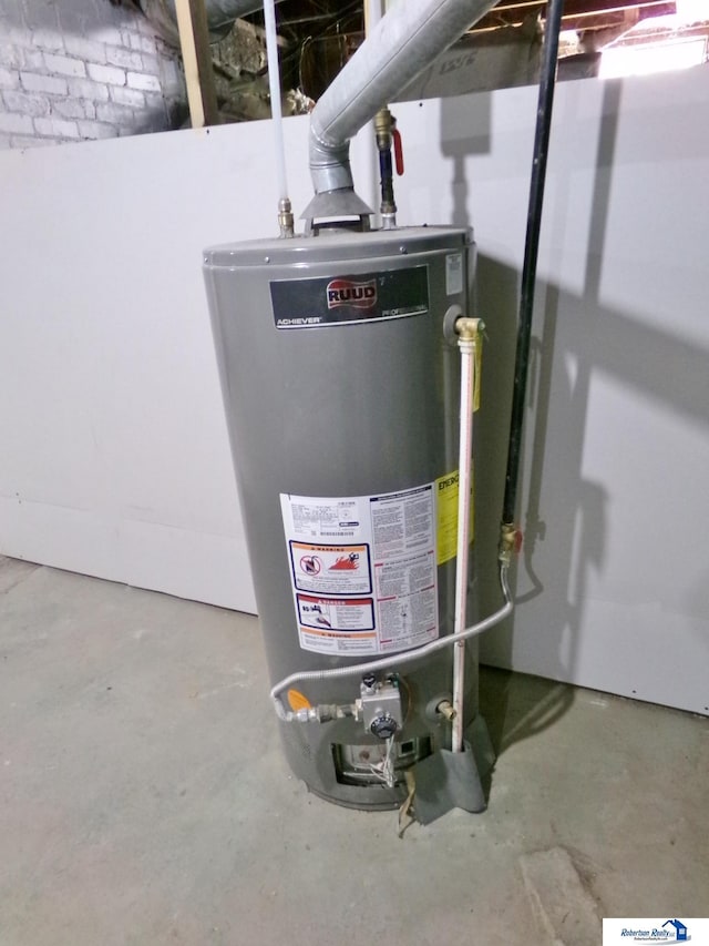 utility room featuring water heater