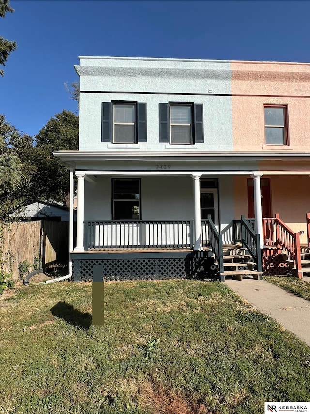 view of front facade with a porch and a front yard