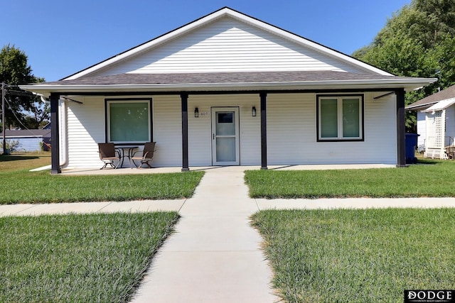 view of front of house with covered porch and a front yard