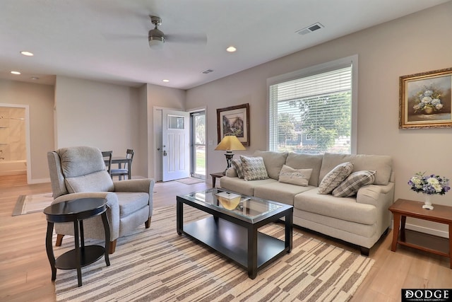 living room featuring ceiling fan and light wood-type flooring