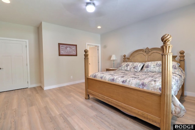 bedroom with light hardwood / wood-style floors and ceiling fan