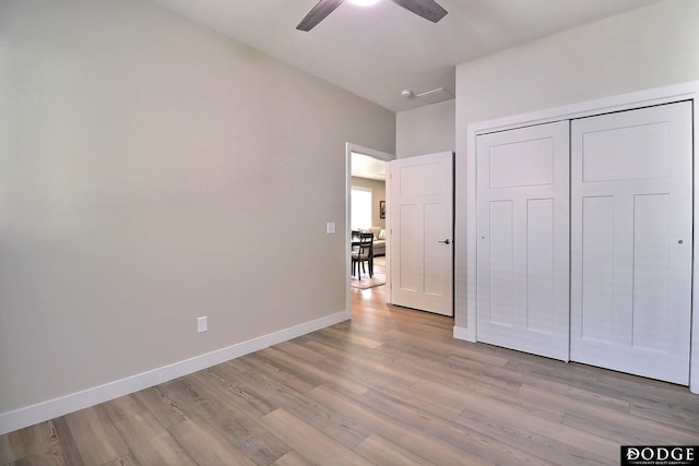 unfurnished bedroom with a closet, ceiling fan, and light hardwood / wood-style flooring