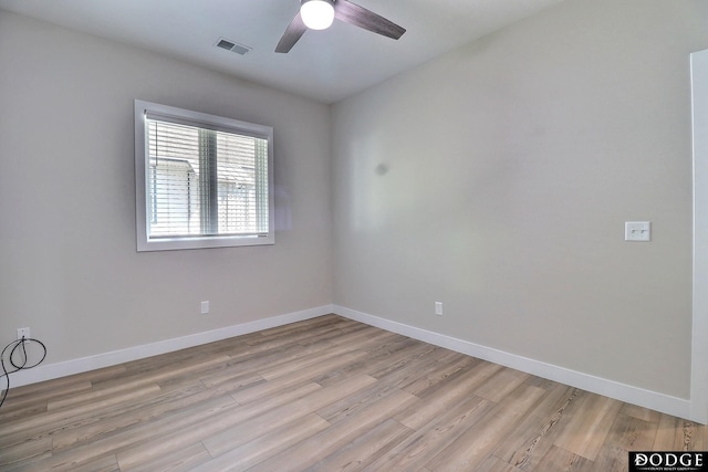 spare room with light wood-type flooring and ceiling fan