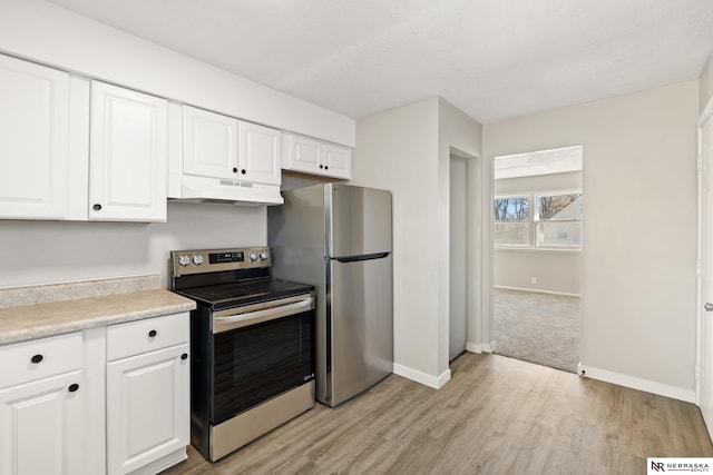 kitchen featuring light hardwood / wood-style floors, white cabinetry, and appliances with stainless steel finishes