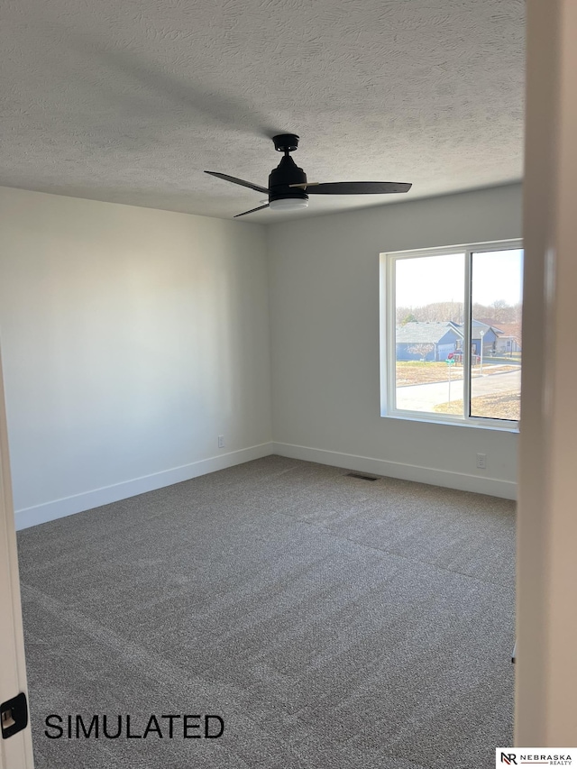 unfurnished room featuring a textured ceiling, carpet floors, and ceiling fan