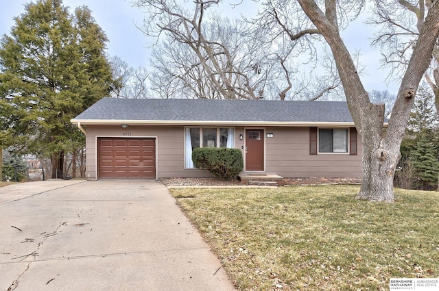 ranch-style home with a front lawn and a garage