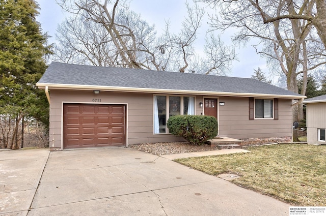 ranch-style house featuring a garage and a front lawn