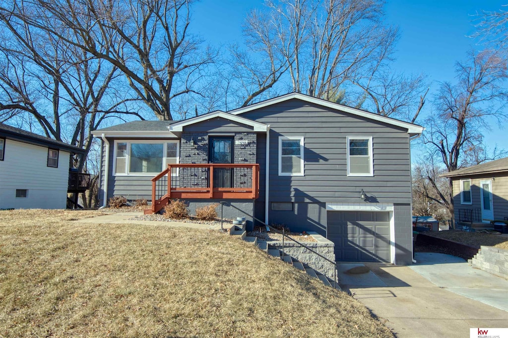 view of front of house with a front yard and a garage