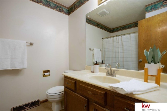 bathroom featuring toilet, vanity, and a shower with curtain