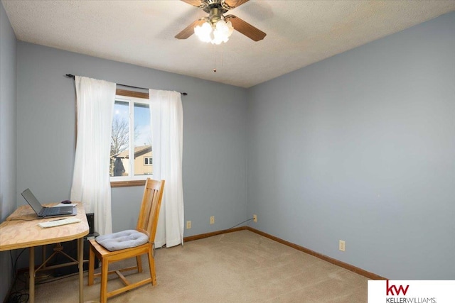 office area with ceiling fan, light colored carpet, and a textured ceiling