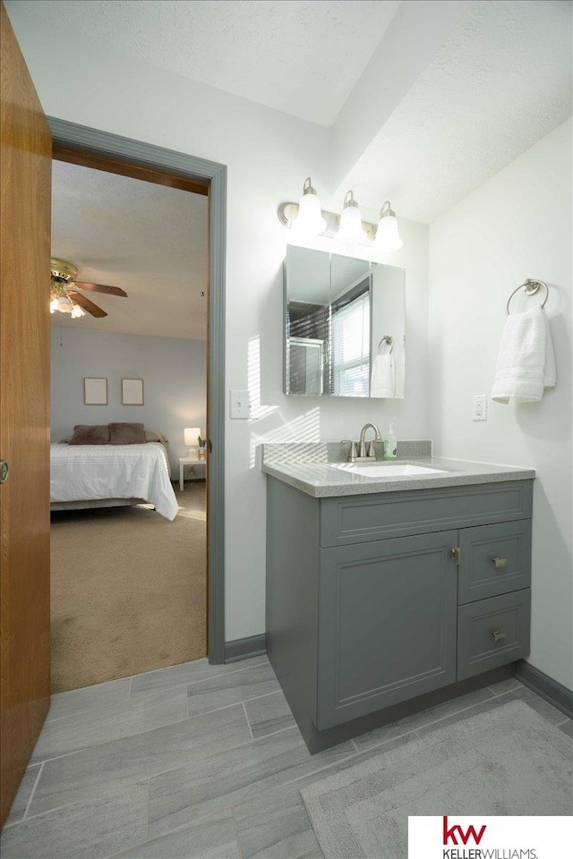 bathroom featuring ceiling fan and vanity