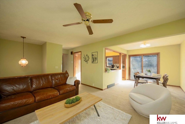 living room with ceiling fan and light colored carpet