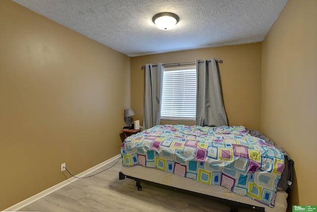 bedroom featuring a textured ceiling and light wood-type flooring