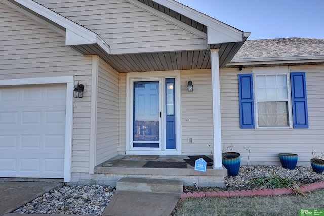 view of exterior entry featuring a garage