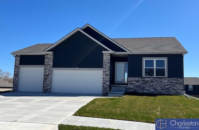 view of front of home featuring concrete driveway, an attached garage, a front yard, and roof with shingles